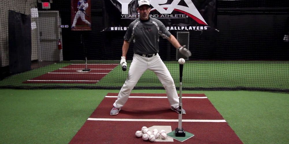 baseball player using a baseball batting tee