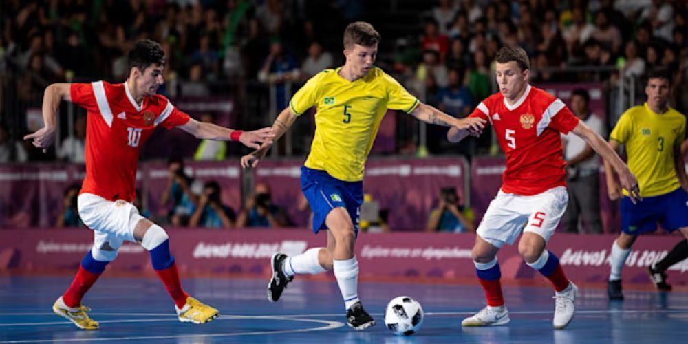 A group of soccer players are playing a game of soccer on a court.