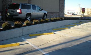 Concrete retaining wall for a drive thru
