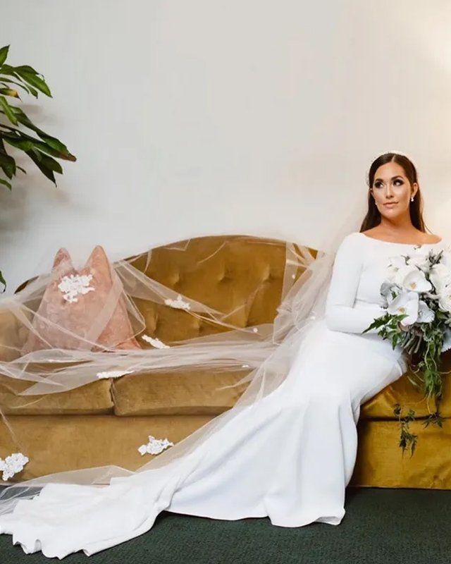 Beautiful bride sitting on sofa
