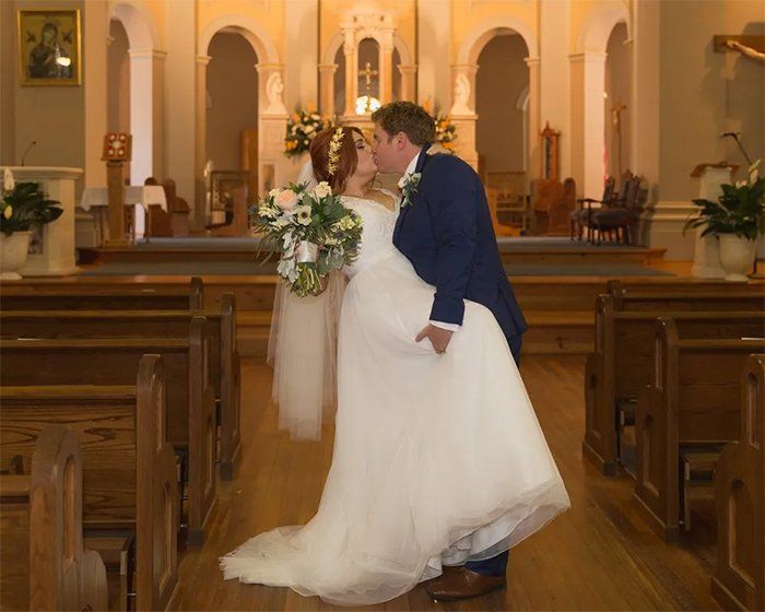 Leslie and james doing wedding kiss