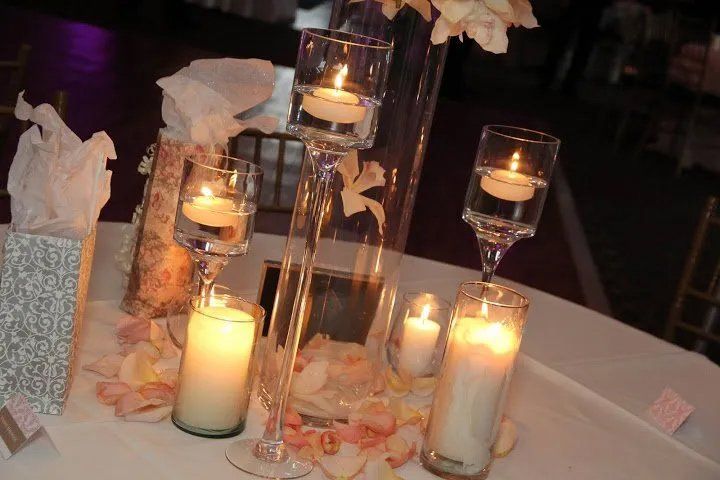 Candles with flower petals on table