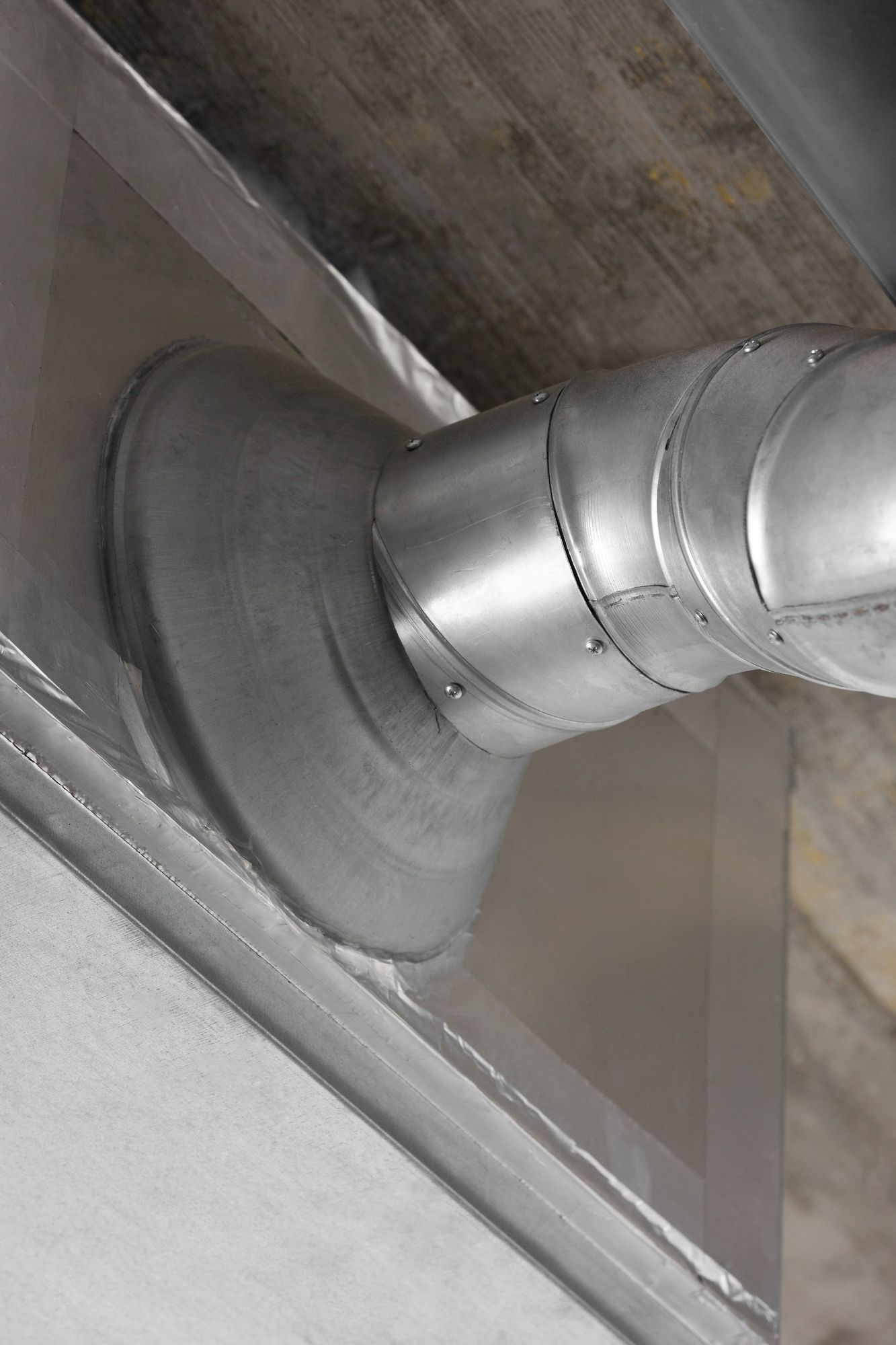 A close-up of a dryer vent on a wall.