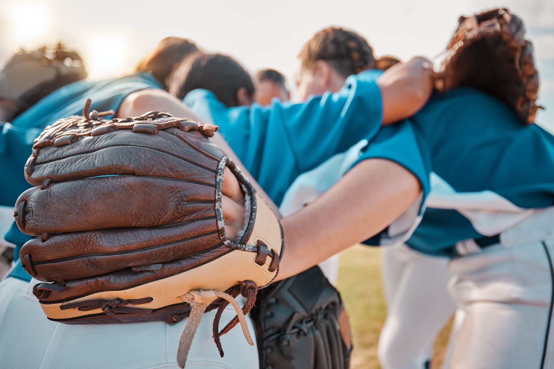 Basketball about to go through a hoop.