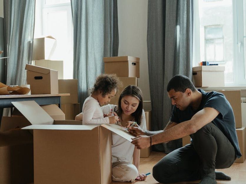 Moving boxes in the living room and the happy family