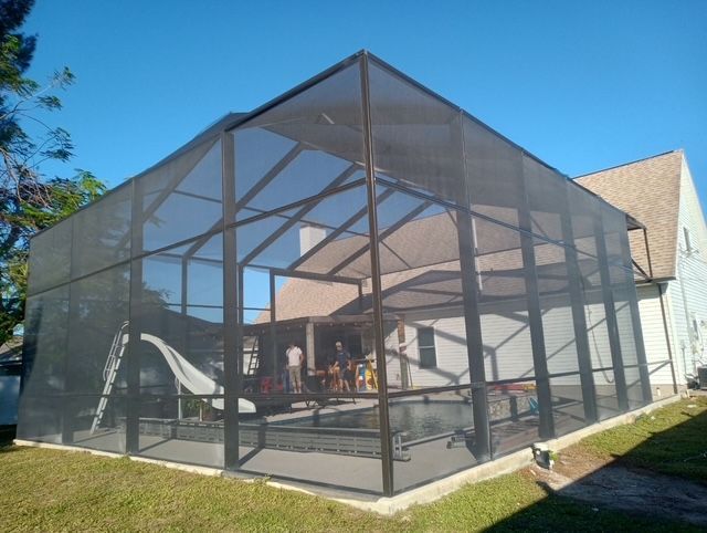 A screened in porch with a slide in it