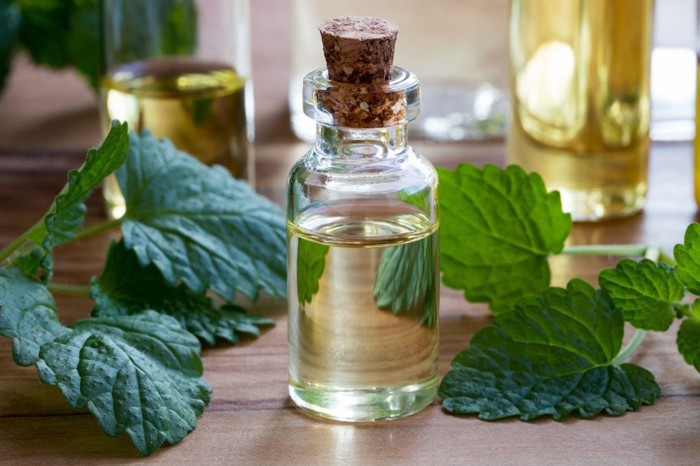 A Bottle Of Essential Oil Sits On A Wooden Table— Naturopath Australia In Byron Bay, NSW