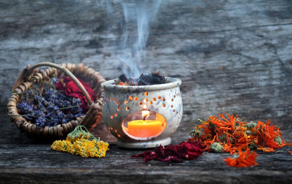 Smoke Is Coming Out Of A Candle Holder Surrounded By Dried Flowers — Naturopath Australia In Byron Bay, NSW