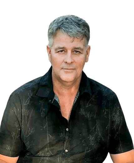 A man in a black shirt is standing in front of a white background.