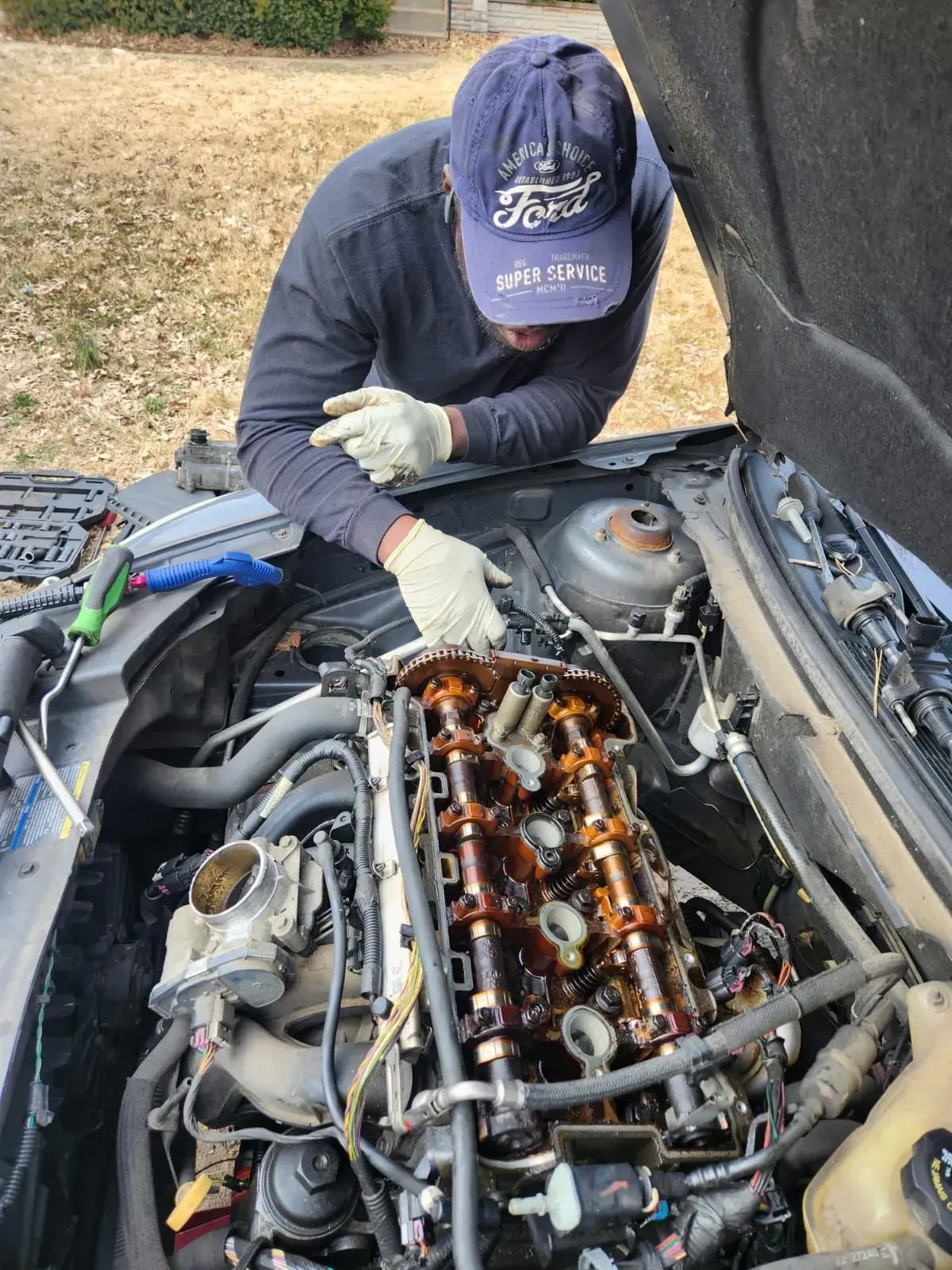 close view of man repairing a car | Strike Force Mobile Mechanic llc