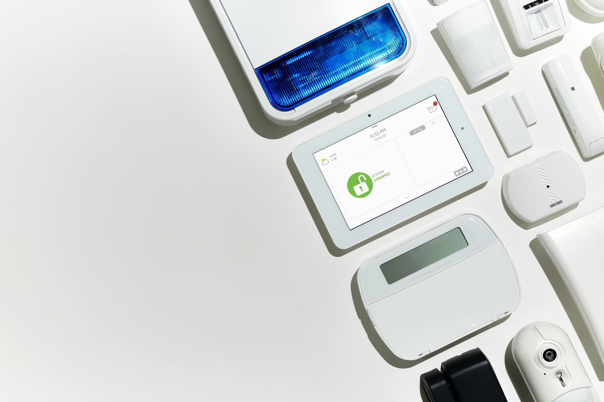 Assorted white smart home devices and gadgets arranged on a light background