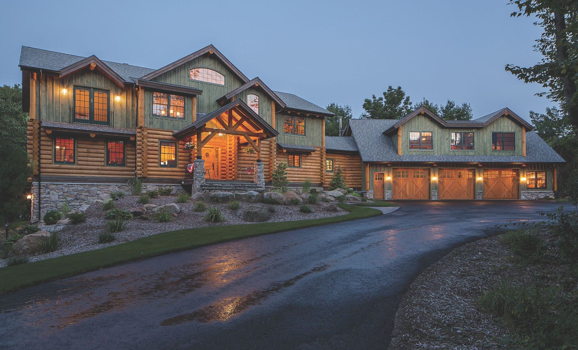 A large house with a lot of windows is sitting on top of a hill.
