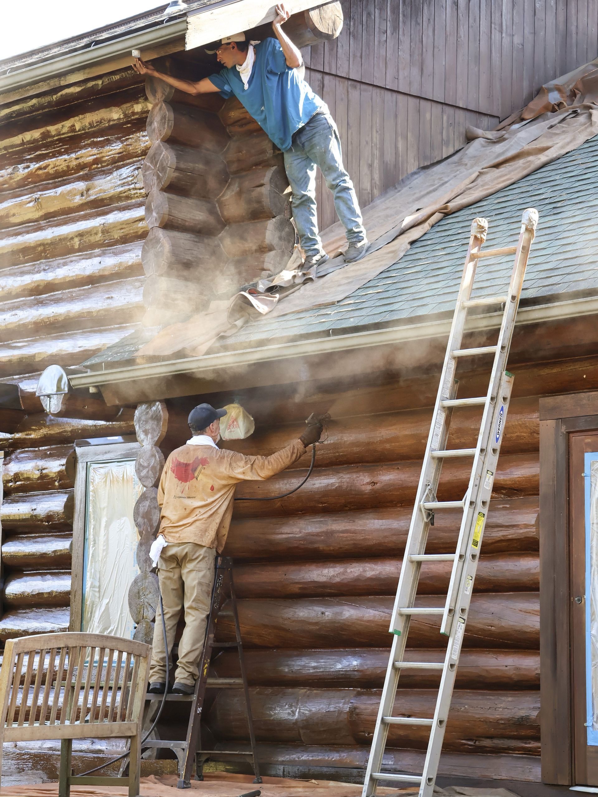 American Log Home Care applying stain to a log home in New England