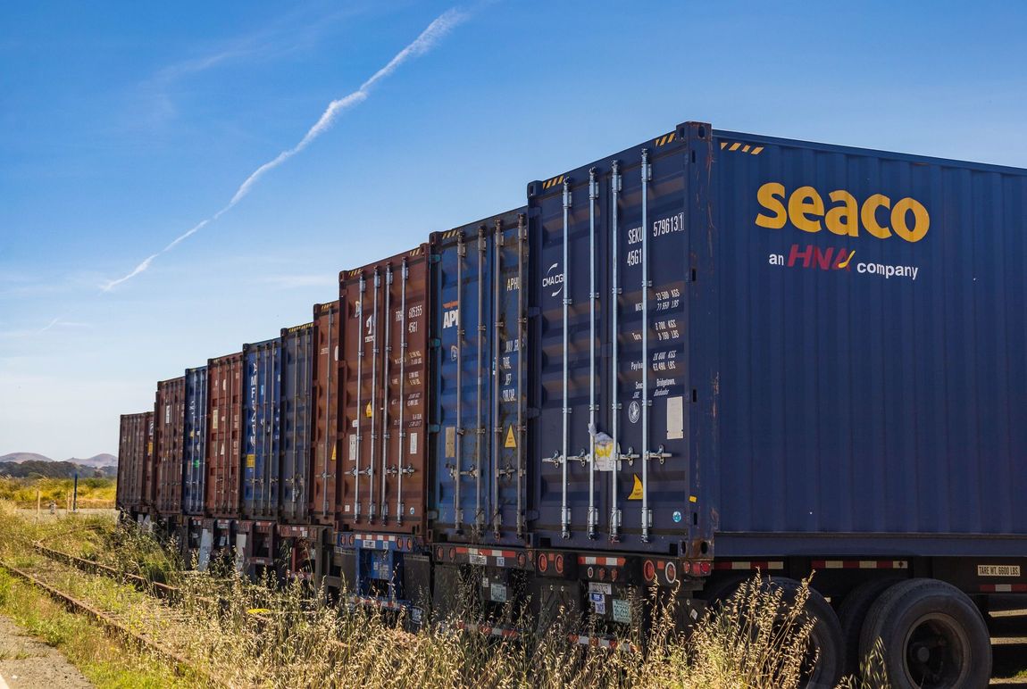 Shipping containers on trucks lined up next to each other
