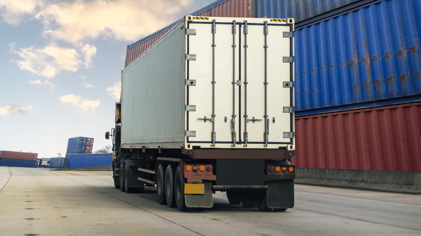 The rear of a truck driving through a freight yard