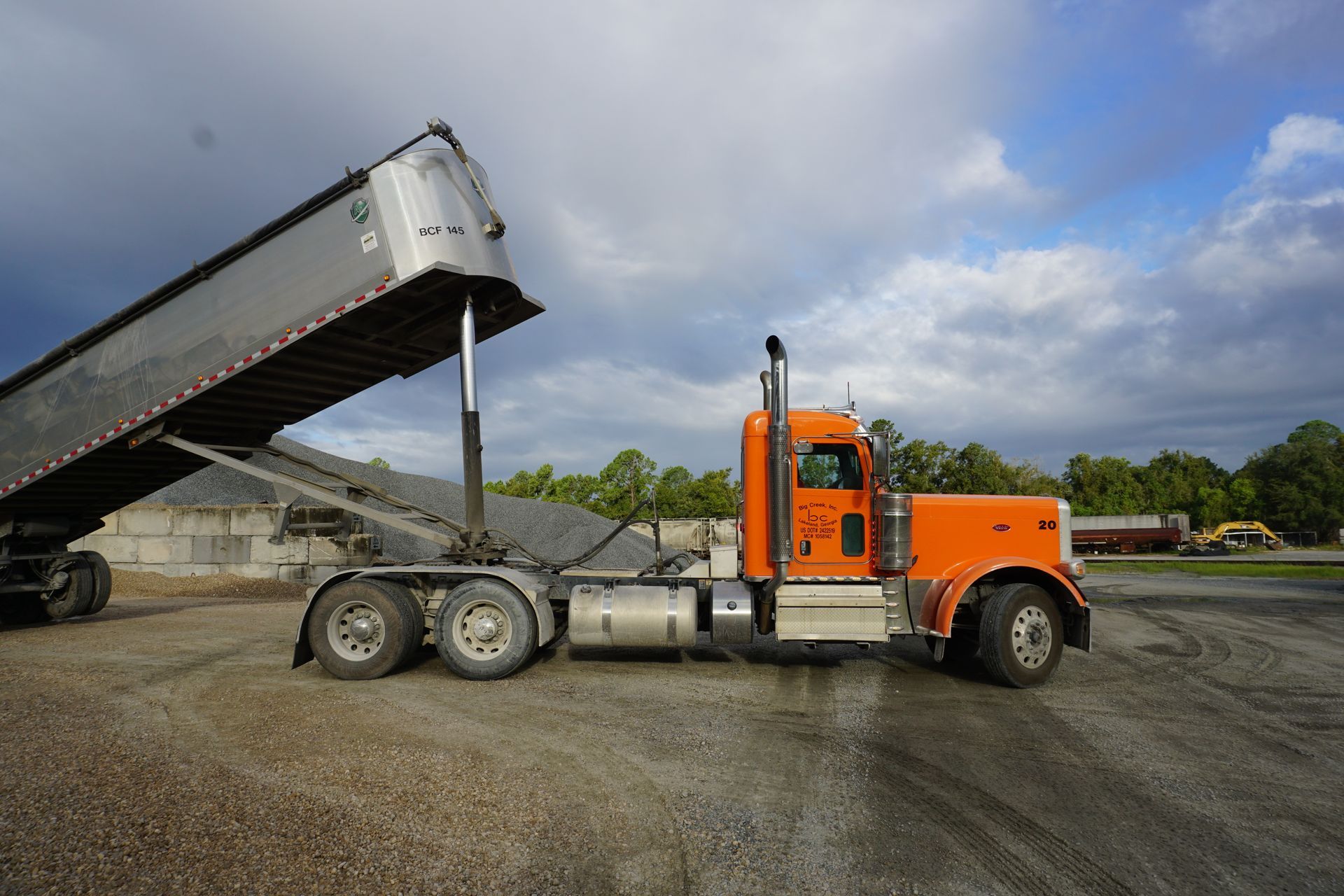 A truck delivering dump trailer hauling services in Savannah.