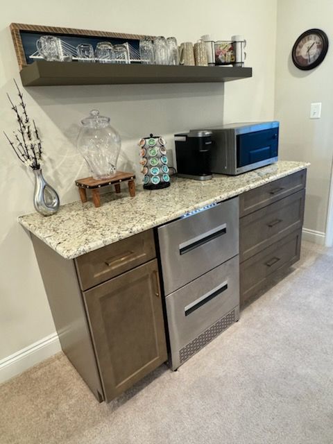 A kitchen with stainless steel appliances and granite counter tops.