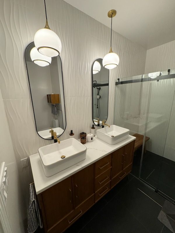 A bathroom with two sinks and two mirrors.