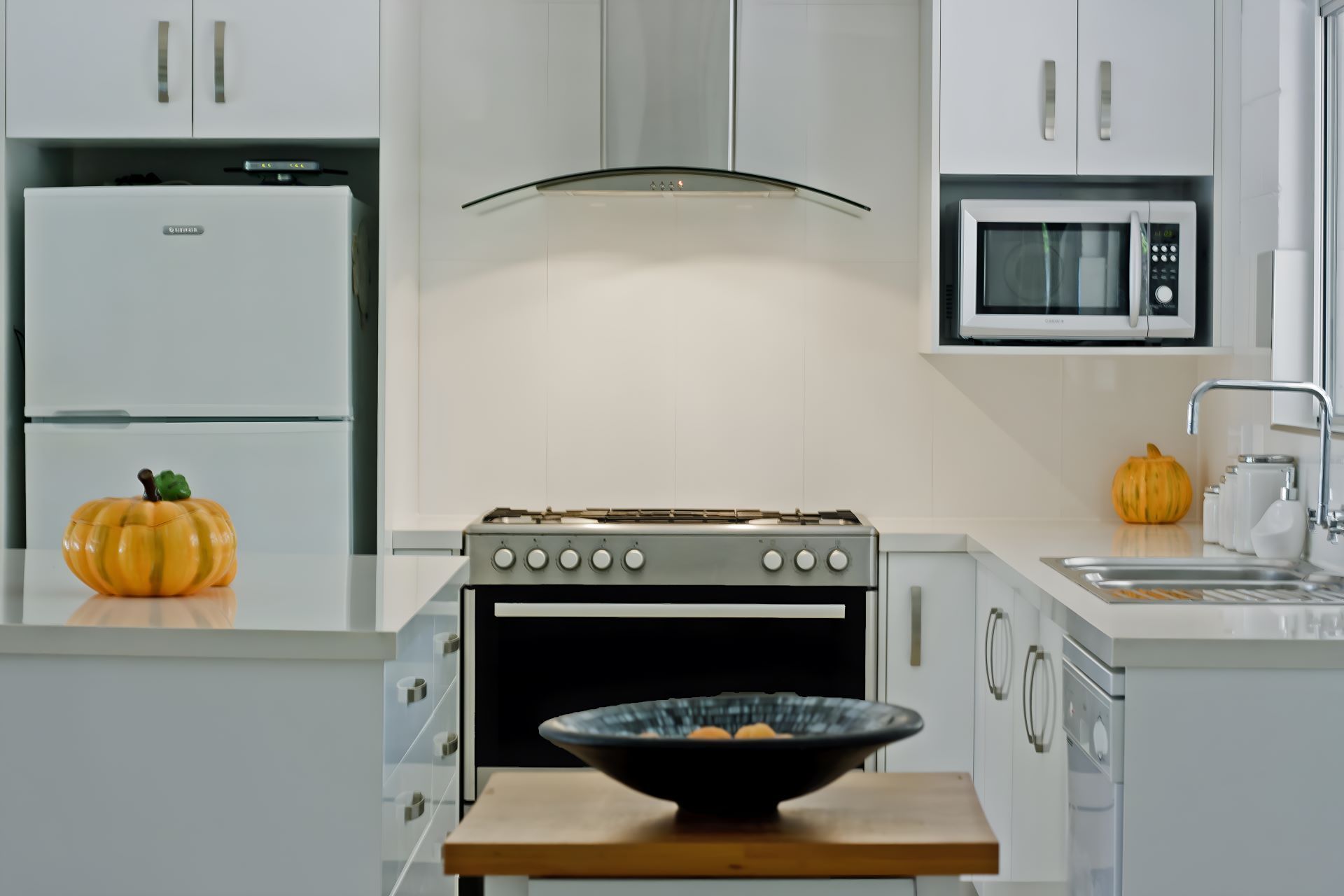 A Kitchen With a Stove a Refrigerator and a Microwave โ Kitchens by CCJS in Bungalow, QLD
