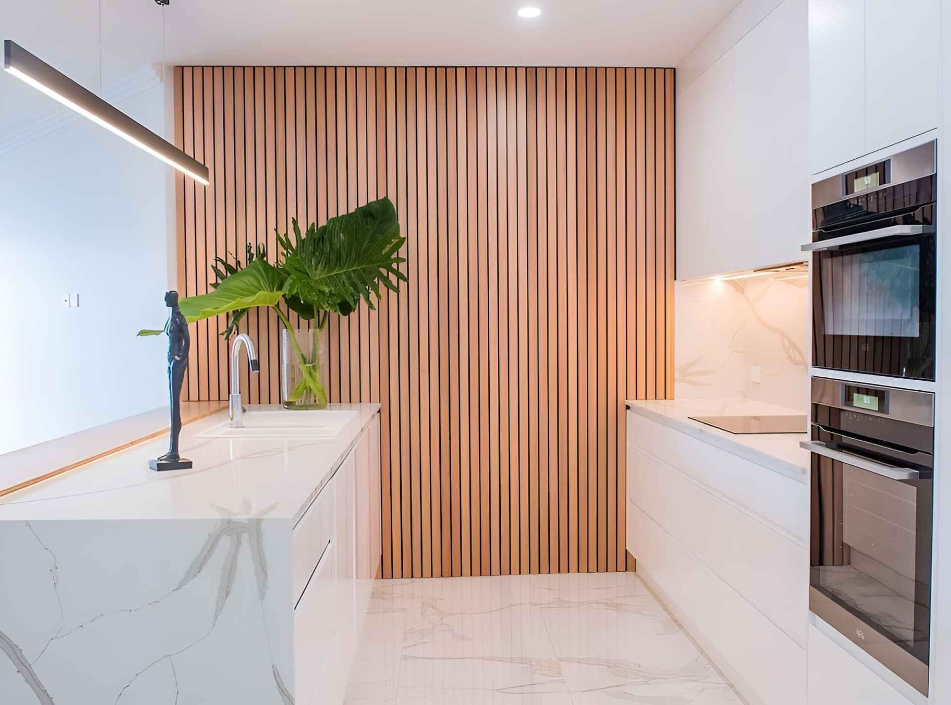 A Kitchen With White Cabinets and a Wooden Wall — Kitchens by CCJS in Bungalow, QLD