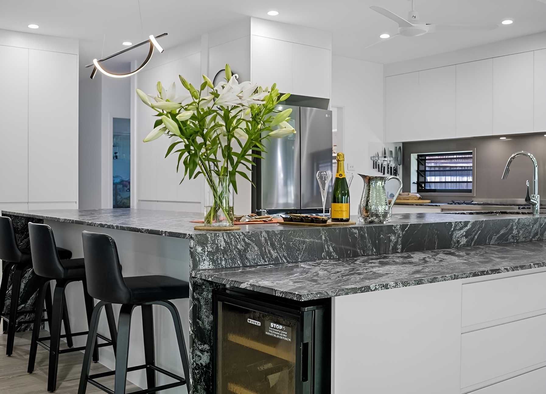 A Kitchen With a Bottle of Champagne on the Counter — Kitchens by CCJS in Mission Beach, QLD