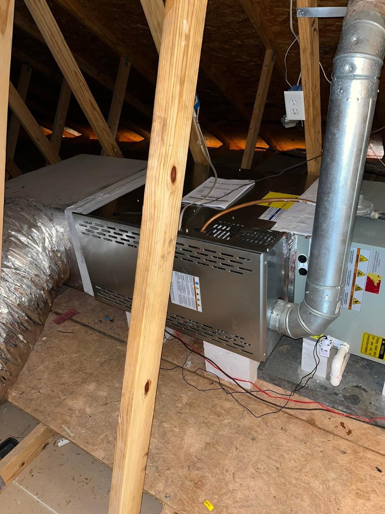 An air conditioner is installed in the attic of a house.