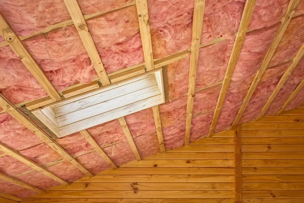 Pink Insulation Installed Between Wooden Rafters — Kev's Group QLD in Kawana, QLD