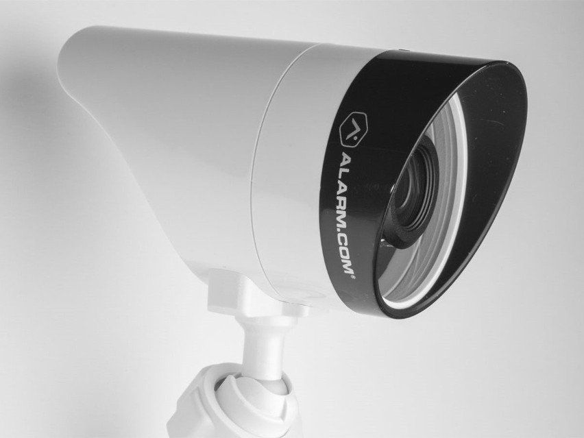 A close up of a camera that says alarmcom on it