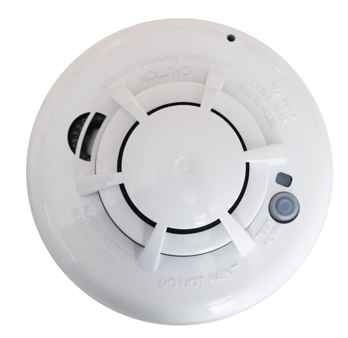A white smoke detector that says
