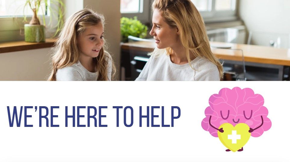 Woman talks with young girl in a kitchen, with