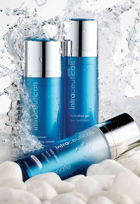 Two Bottles of Intracellulars are Splashed with Water — Bernadette's Beauty Care in Sarina, QLD