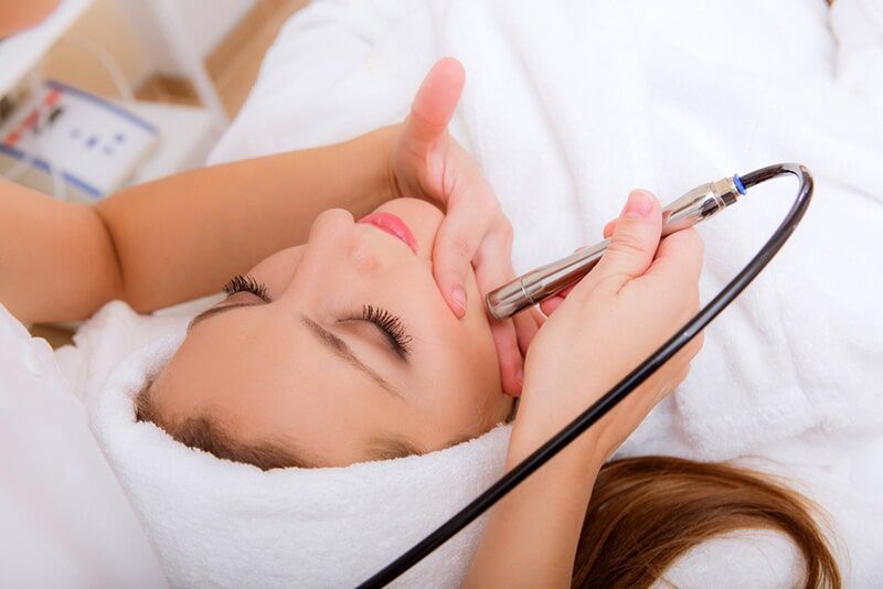 A Woman is Getting a Facial Treatment at a Beauty Salon — Bernadette's Beauty Care in Sarina, QLD