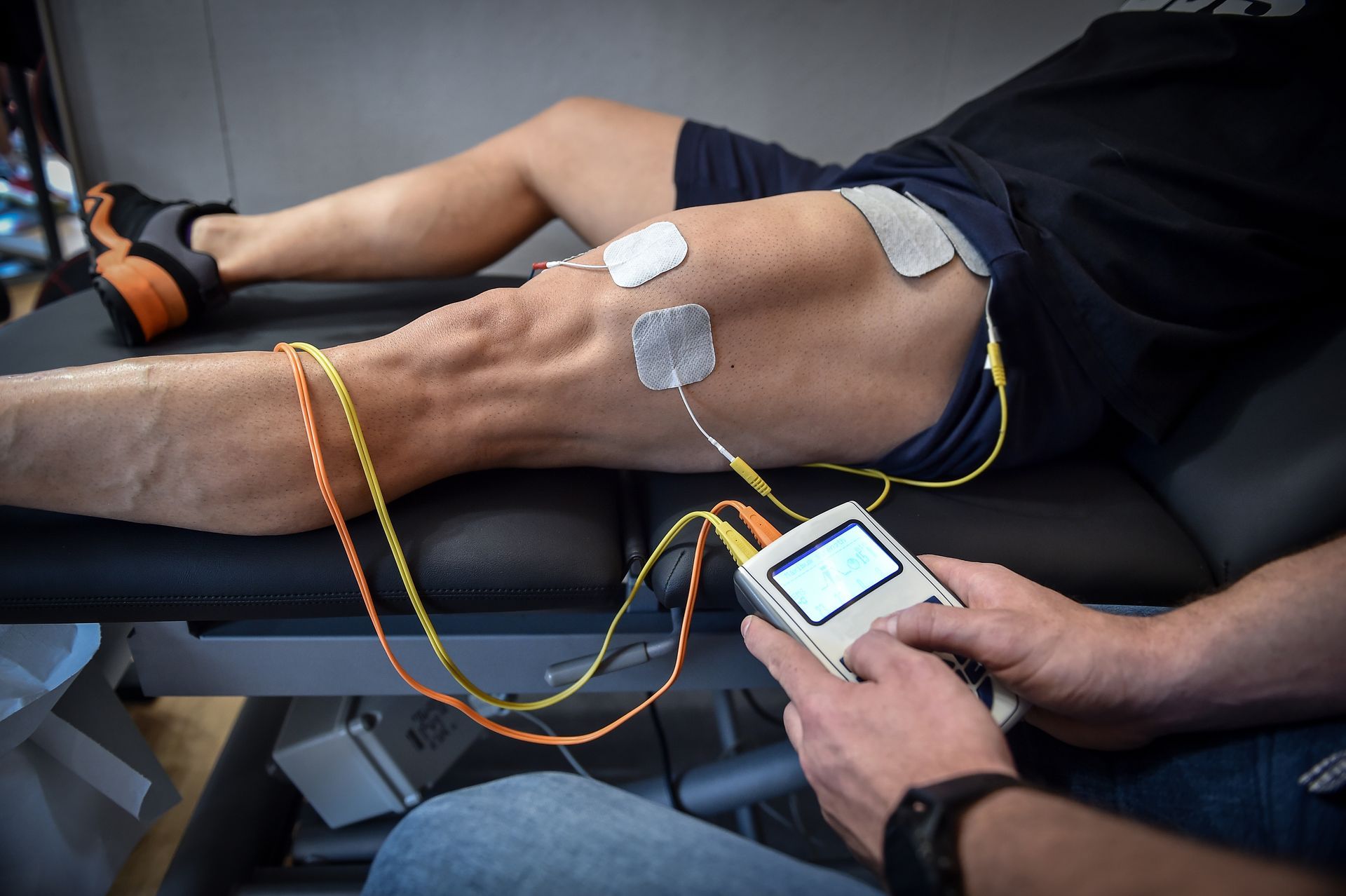 A person is using a device on a person 's leg.