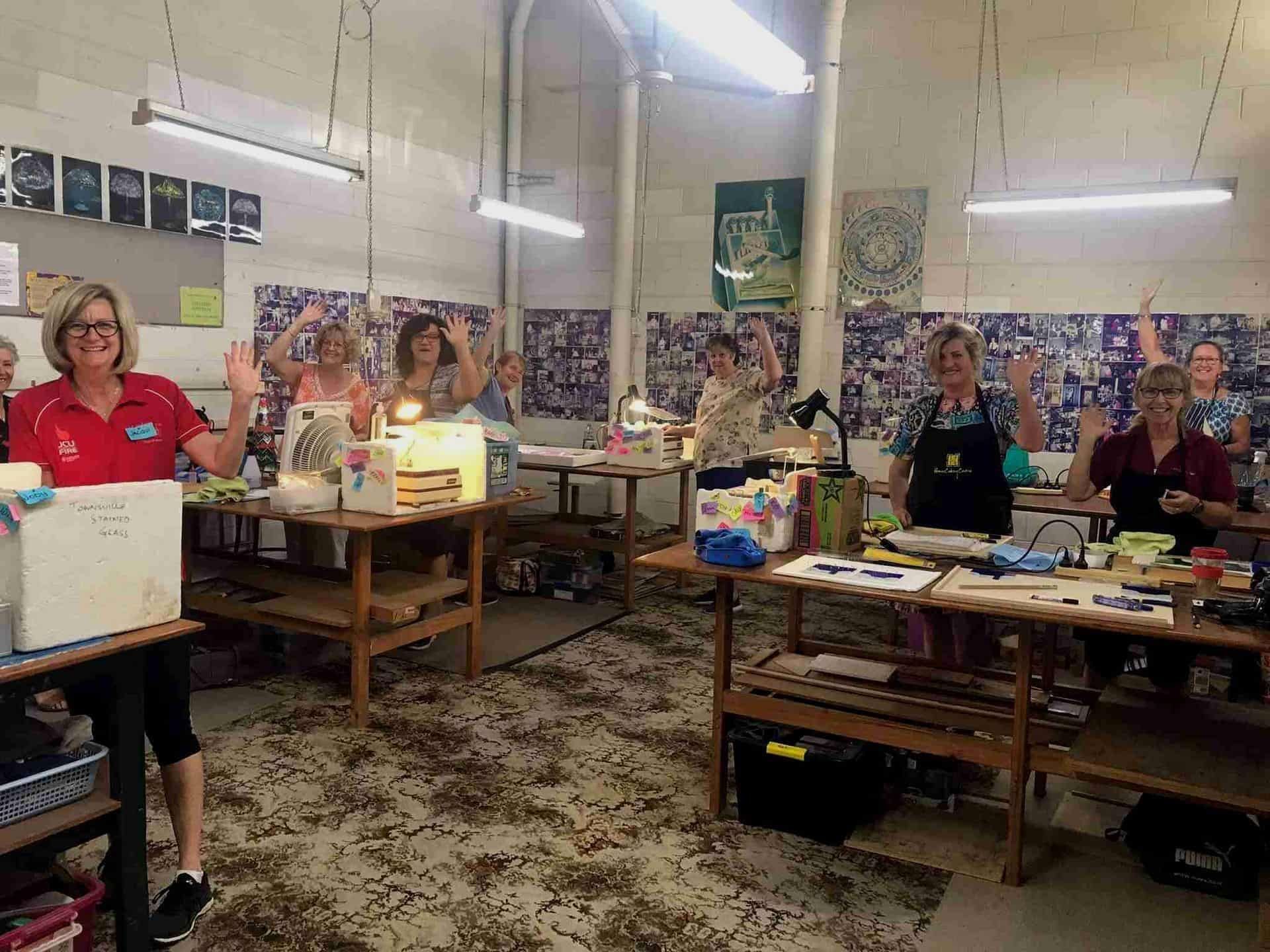 A Group Of Women Are Sitting At Tables In A Room — Townsville Stained Glass In Aitkenvale, QLD 