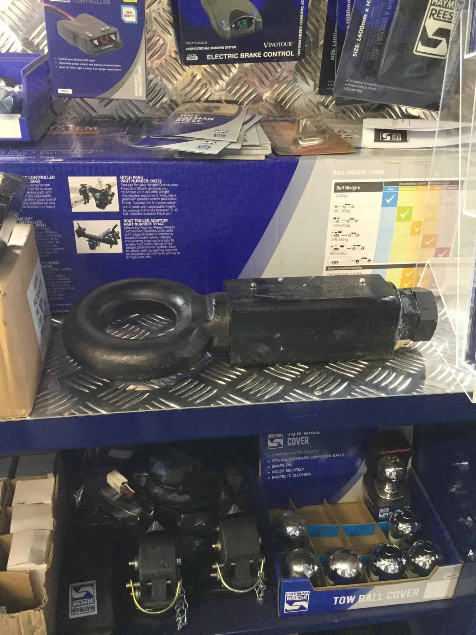 A Shelf With a Bunch of Boxes and a Tire on It — B & C Caravan Service Pty Ltd In Dubbo, NSW