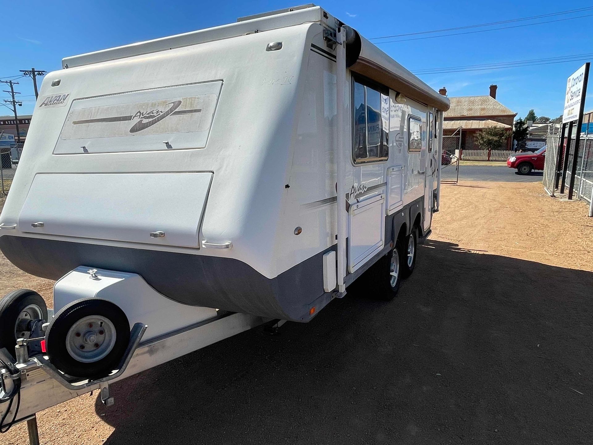White Travel Trailer Parked Outdoors on a Sunny Dirt Lot — B & C Caravan Service Pty Ltd In Dubbo, NSW