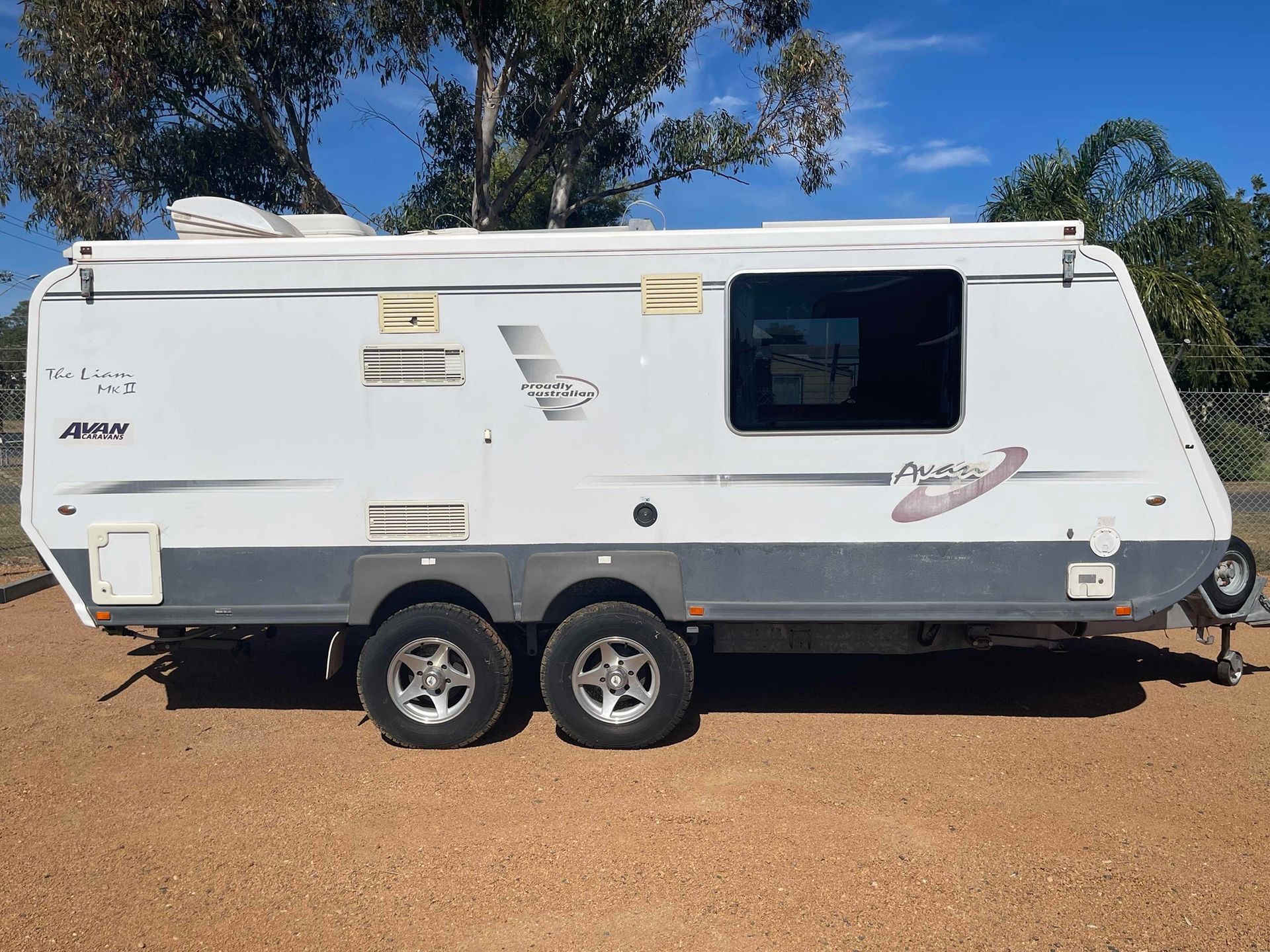 White Tandem-axle Travel Trailer Parked — B & C Caravan Service Pty Ltd In Dubbo, NSW