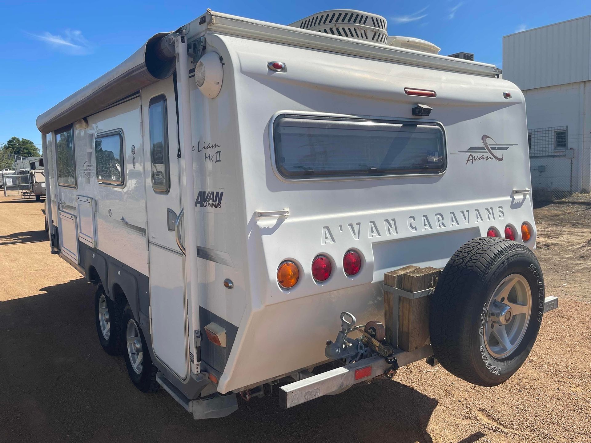 White Travel Trailer Parked on Gravel, Rear View — B & C Caravan Service Pty Ltd In Dubbo, NSW