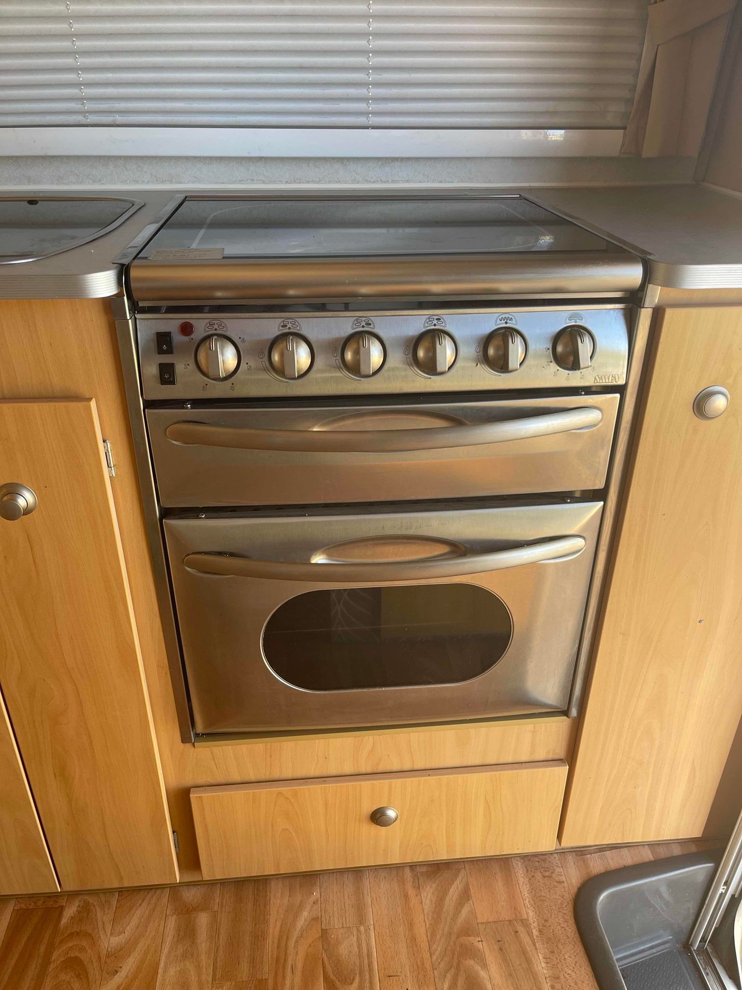 Compact Stainless-steel Stove With Oven in a Light Wood Kitchen — B & C Caravan Service Pty Ltd In Dubbo, NSW