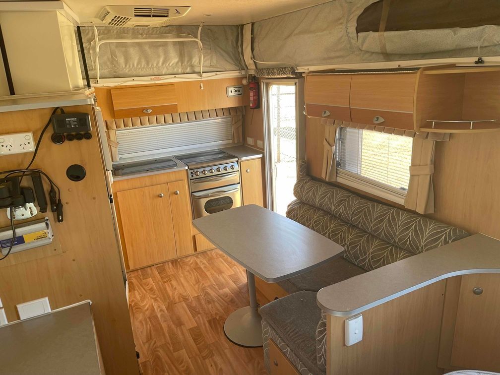 Compact Rv Interior With Wood Paneling, Kitchenette — B & C Caravan Service Pty Ltd In Dubbo, NSW