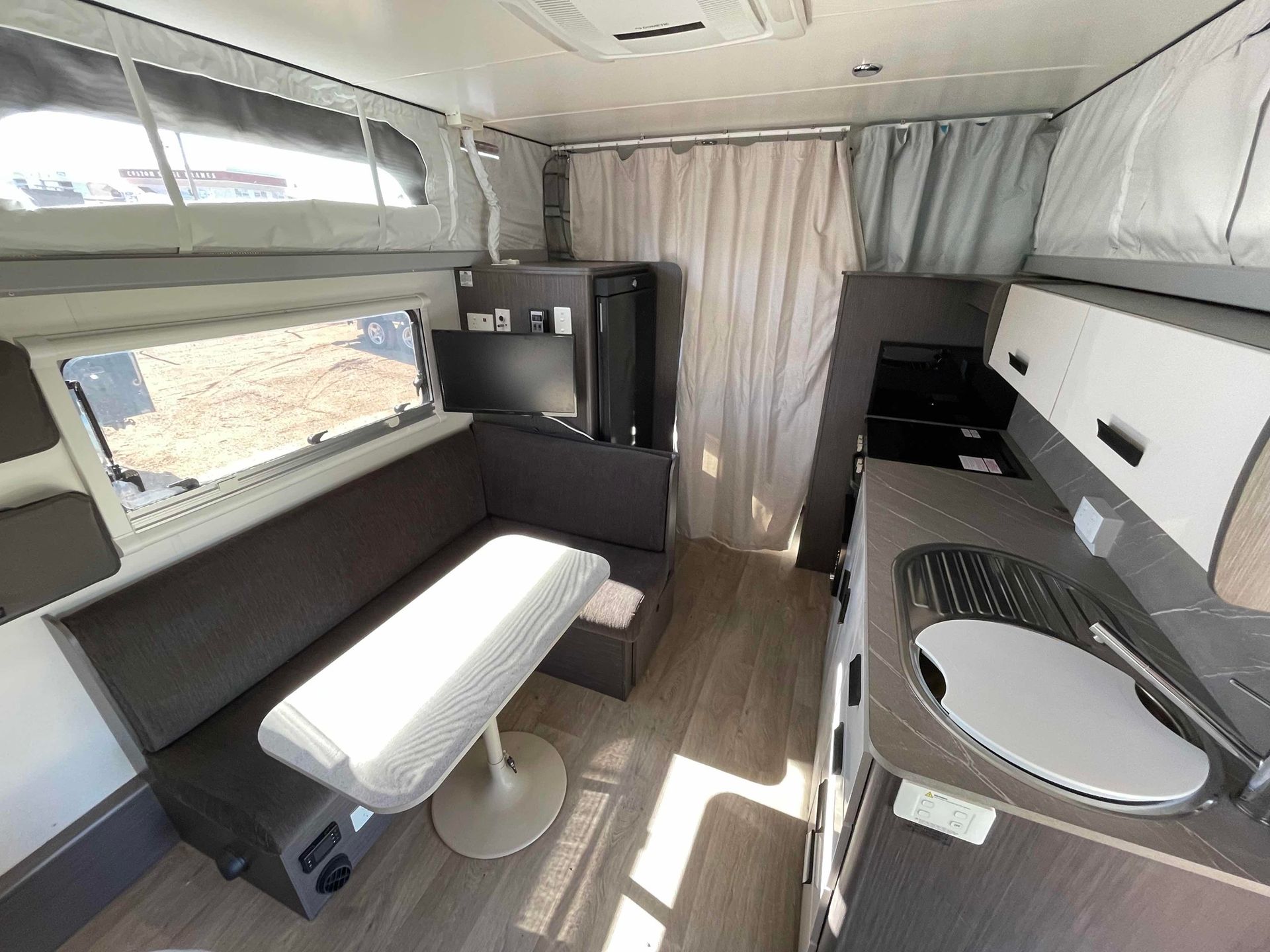 Compact Camper Van Interior With Bench, Table, Kitchenette — B & C Caravan Service Pty Ltd In Dubbo, NSW