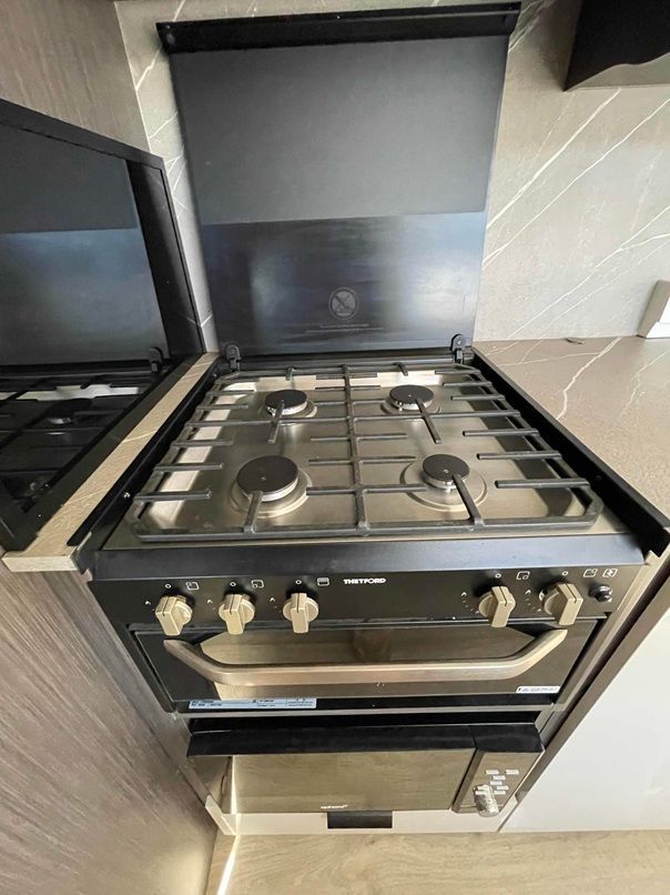 Compact Stainless-steel Gas Stove in a Modern Kitchen — B & C Caravan Service Pty Ltd In Dubbo, NSW