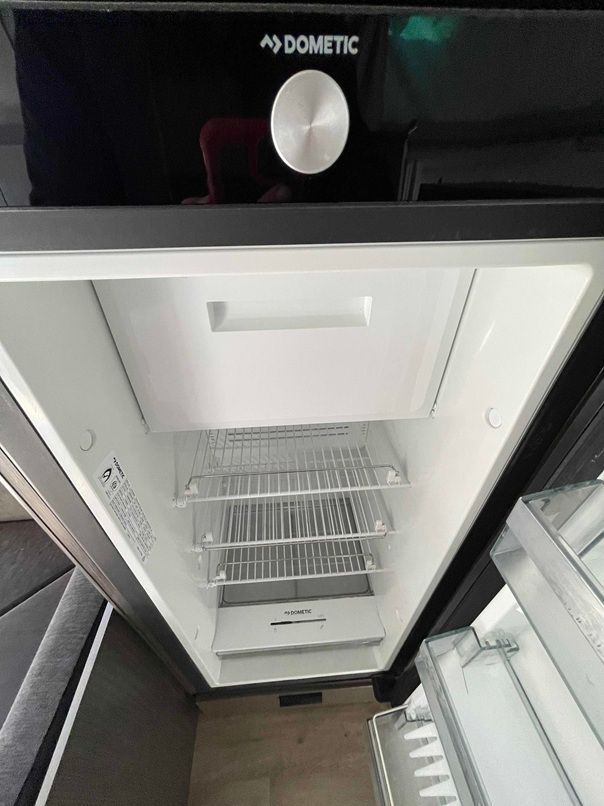 Open Mini Fridge With White Shelves and Drawers — B & C Caravan Service Pty Ltd In Dubbo, NSW