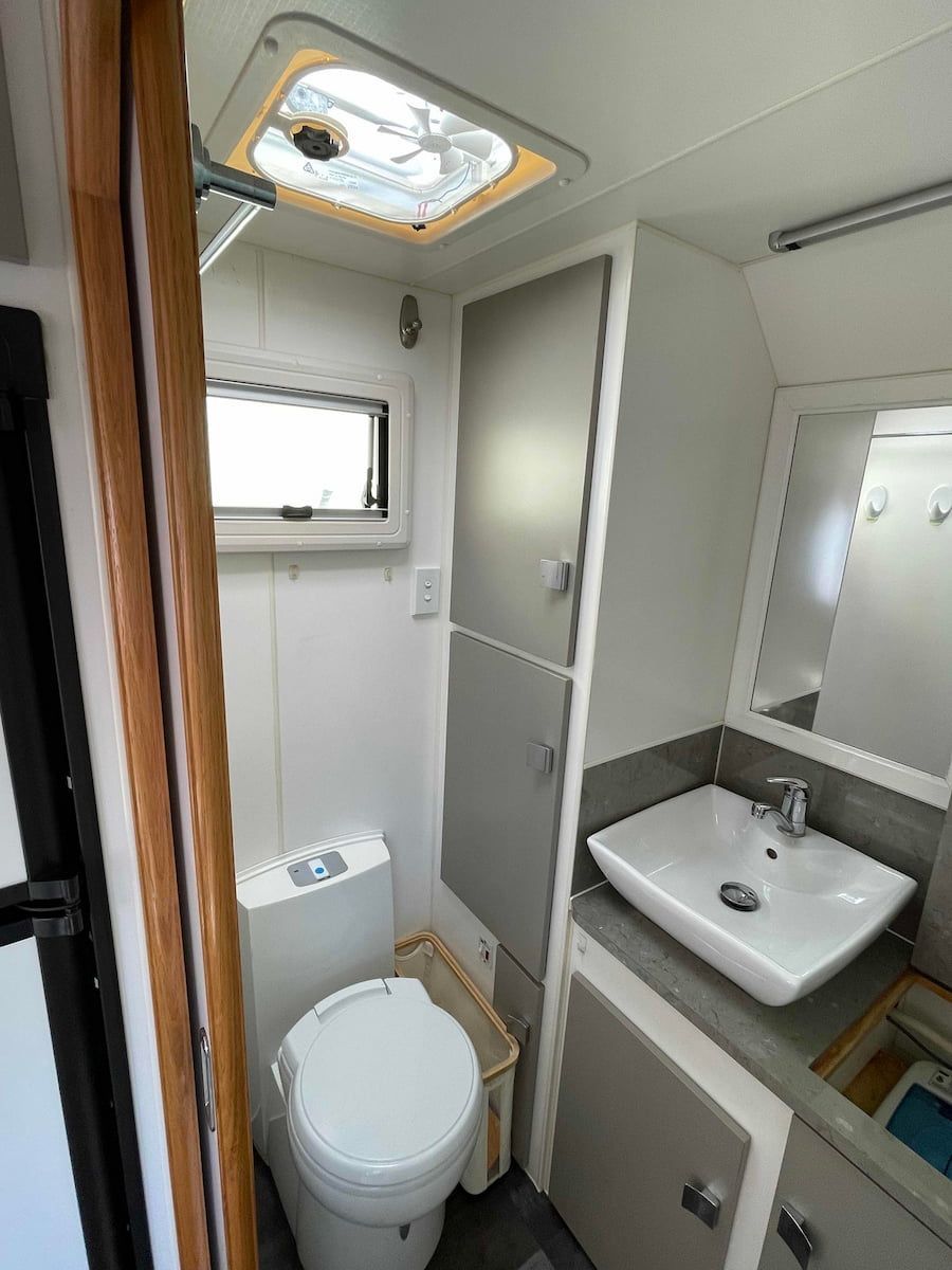 Compact Rv Bathroom With Toilet, Sink, Mirror — B & C Caravan Service Pty Ltd In Dubbo, NSW