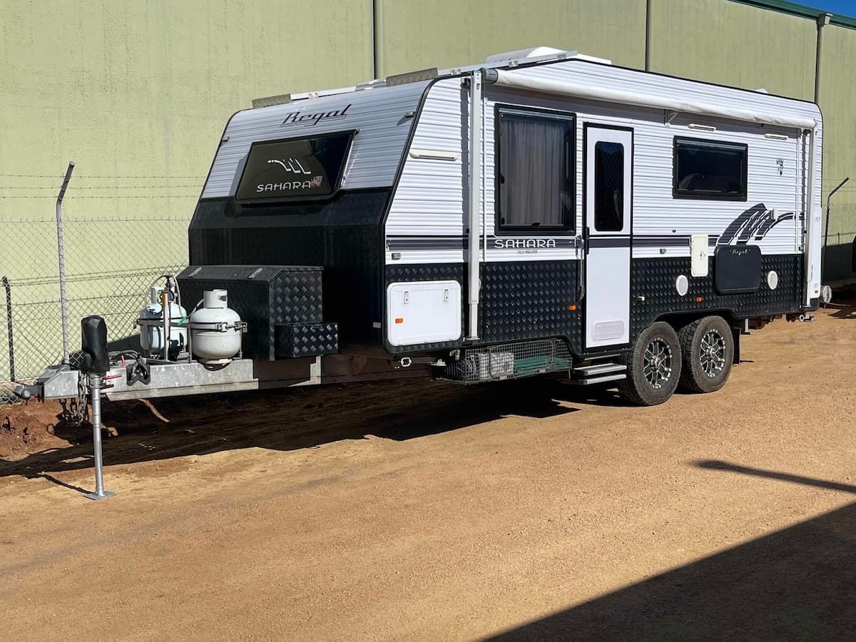 White and Black Off-road Camper Trailer With Dual Axles and Front Hitch Parked — B & C Caravan Service Pty Ltd In Dubbo, NSW