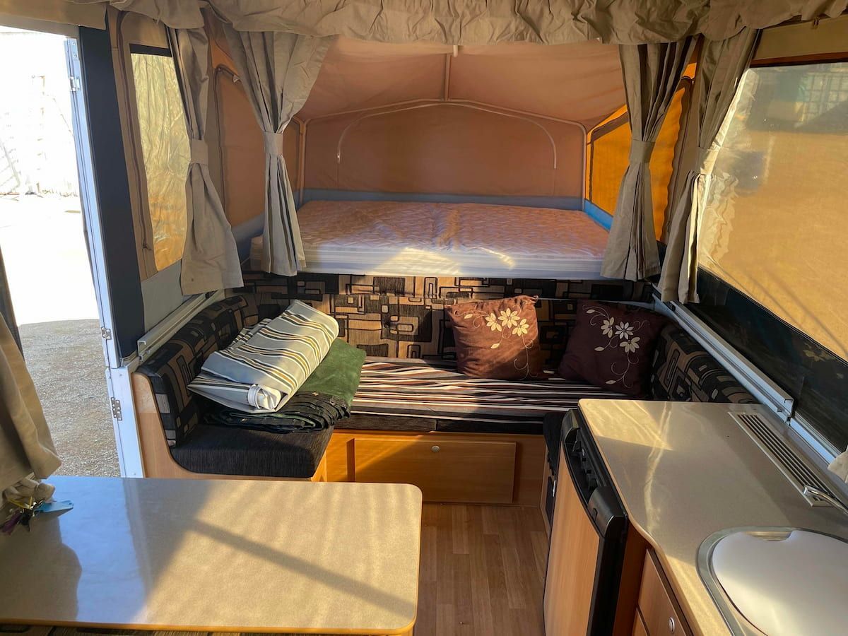 Interior of a Compact Camper Van With a Bed Platform — B & C Caravan Service Pty Ltd In Dubbo, NSW