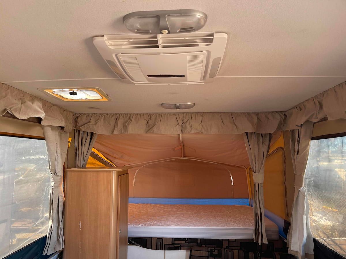 Interior of a Camper Van With Curtains, Ceiling Vent — B & C Caravan Service Pty Ltd In Dubbo, NSW