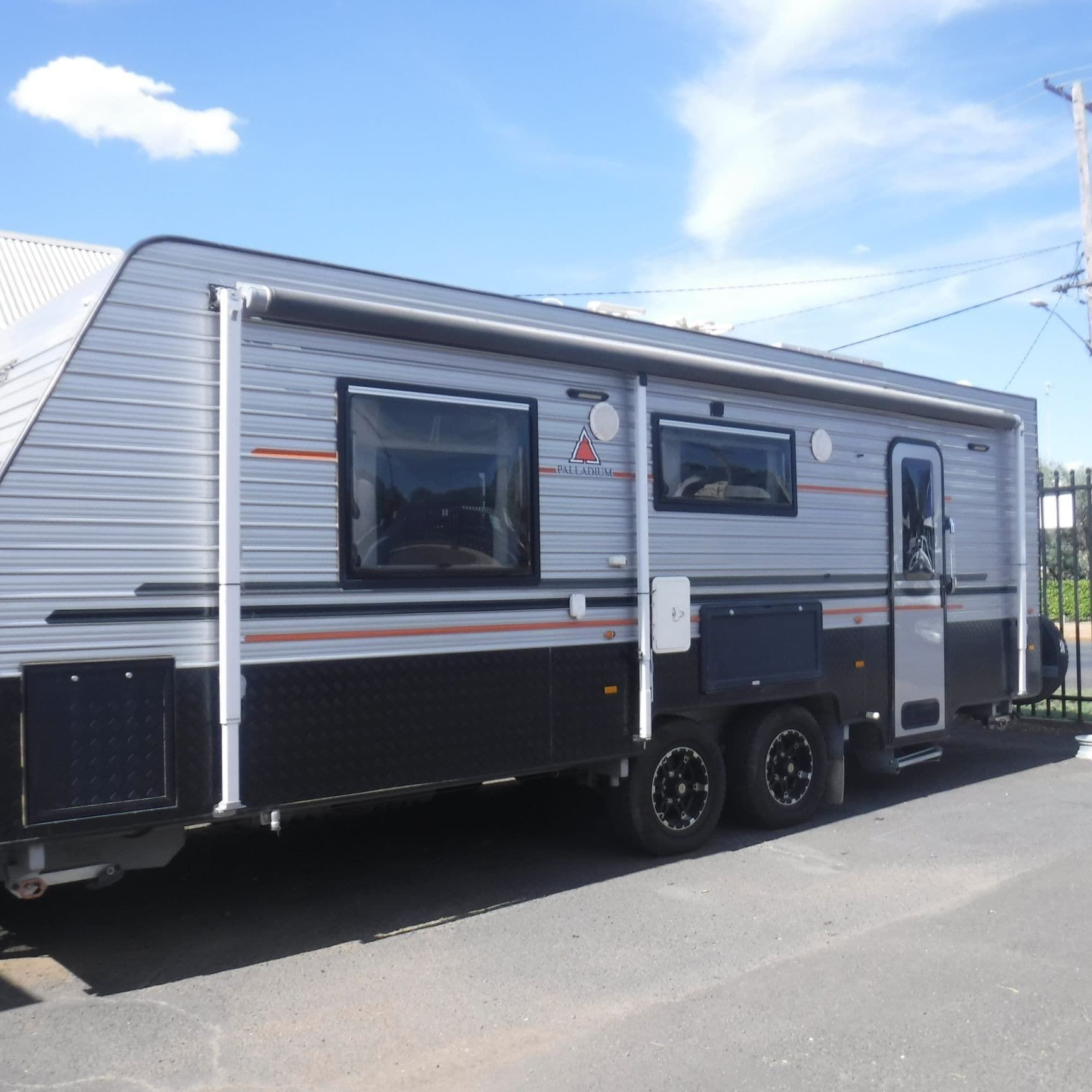 A Grey and Black Rv is Parked on the Side of the Road — B & C Caravan Service Pty Ltd In Dubbo, NSW