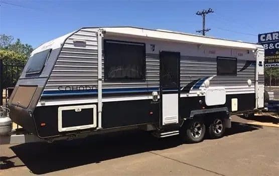 A Silver and Black Trailer is Parked on the Side of the Road — B & C Caravan Service Pty Ltd In Dubbo, NSW