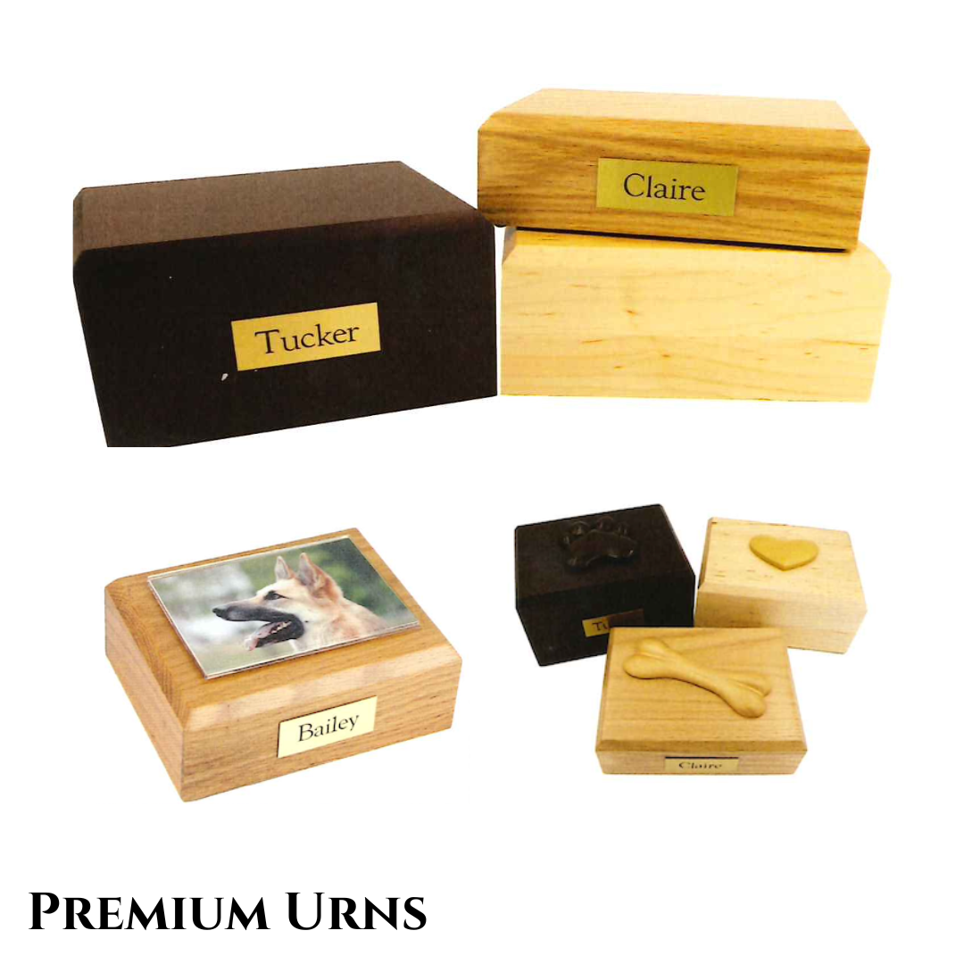 Multiple wooden urns, one has a dog figurine on top and others have wooden figurines on the urn lids; all ures are engraved